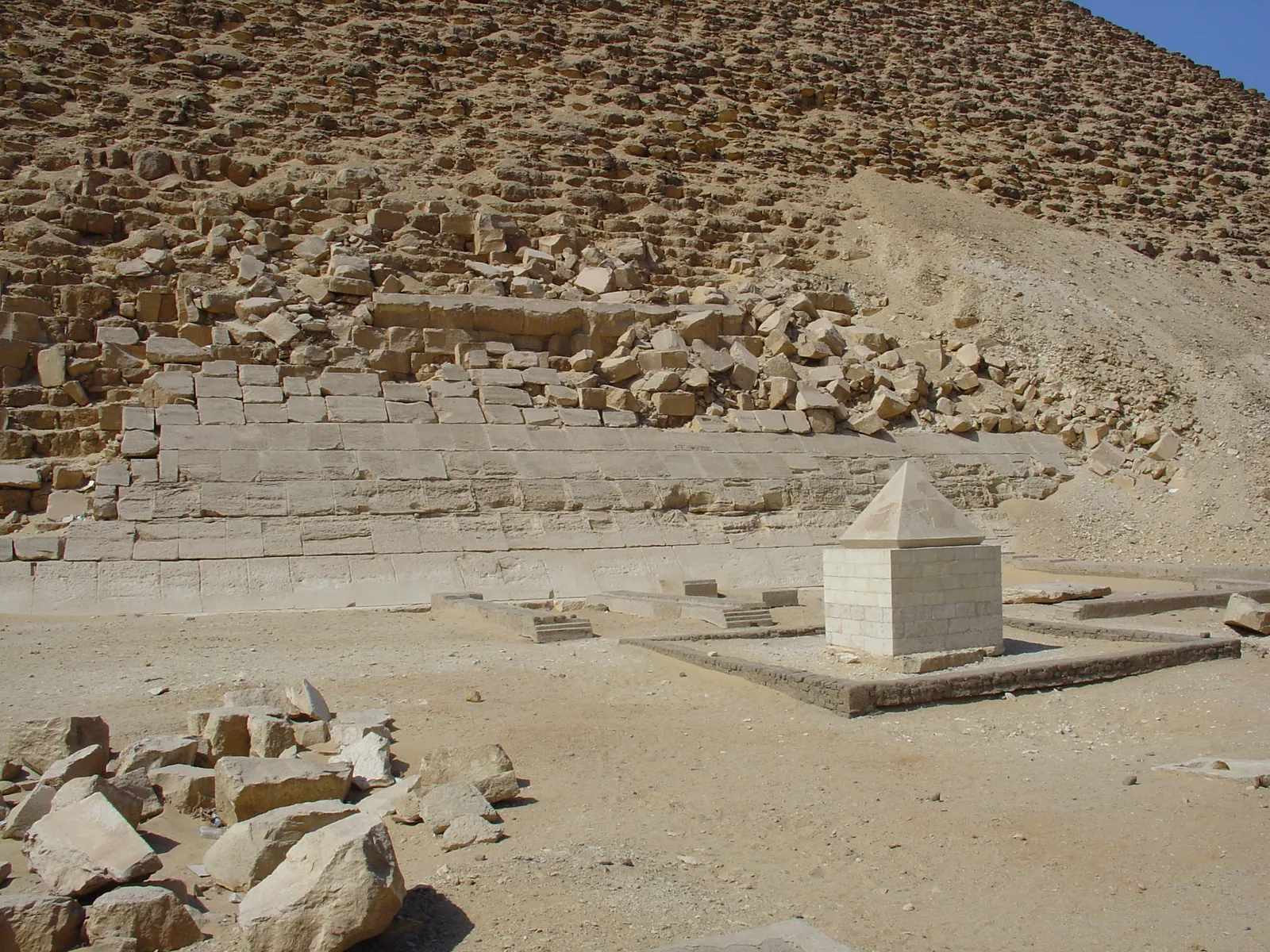Röda pyramidens hopfogade toppsten (pyramidion) av Turakalksten, utställd bredvid pyramiden i Dahshur (dag 4). Alla kända toppstenar från 4:e dynastin är av enkel vit kalksten; lägg märke till att den här är brantare än själva pyramiden.